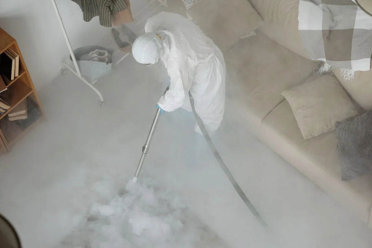 Biohazard cleanup technician in protective equipment, Fayette, IA